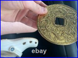 Chinese gold face sized coin Chinese words and Chinese animals on it